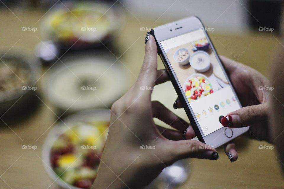 Taking photo of food on mobile phone 
