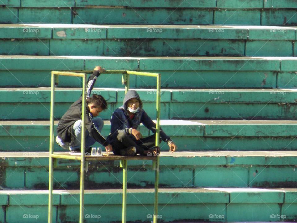 Spectators down the stairs in a Marvel colored football stadium