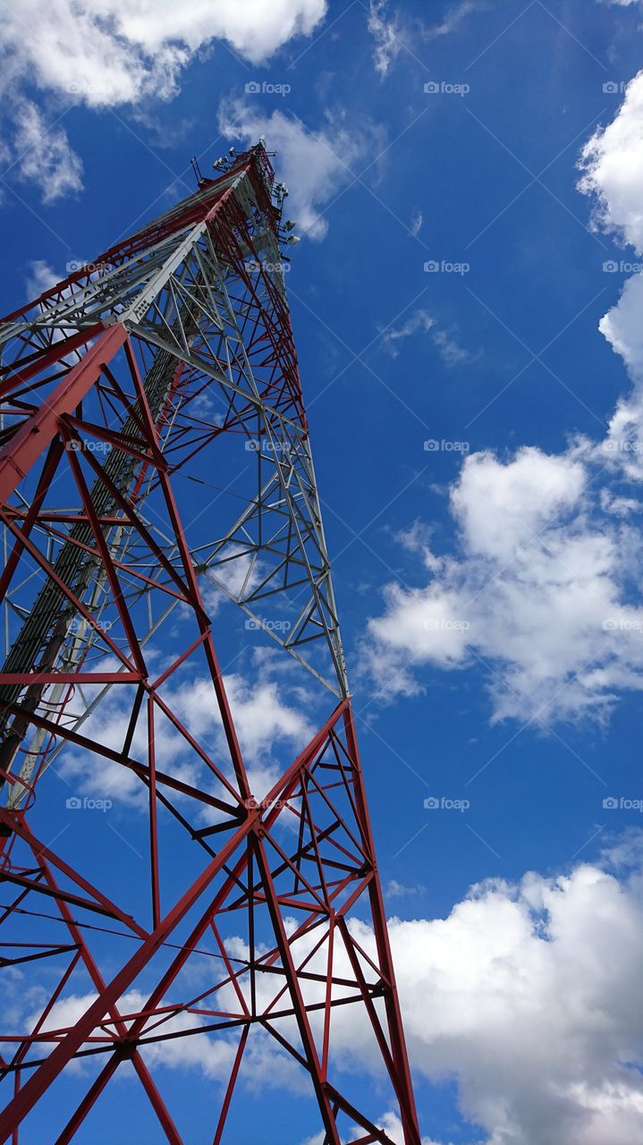 Mobile phone tower on bright blue sky