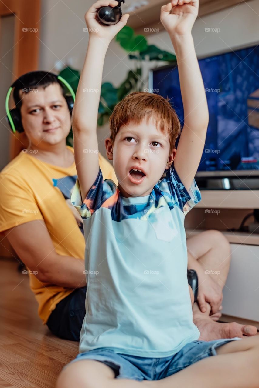 Boy and dad playing video game 