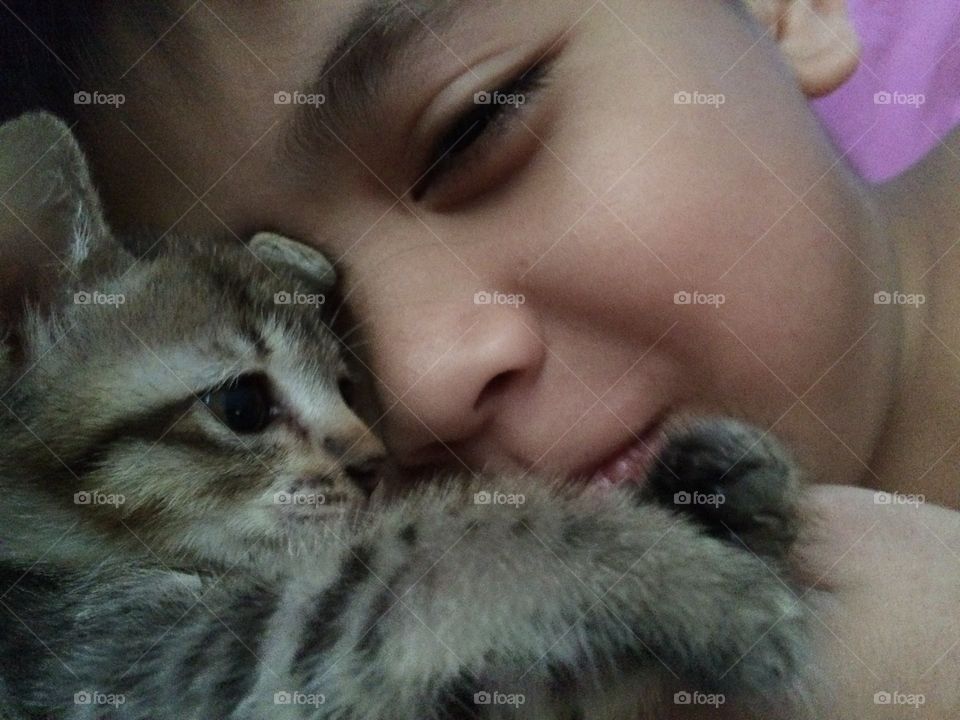 Close-up of boy with the his cat