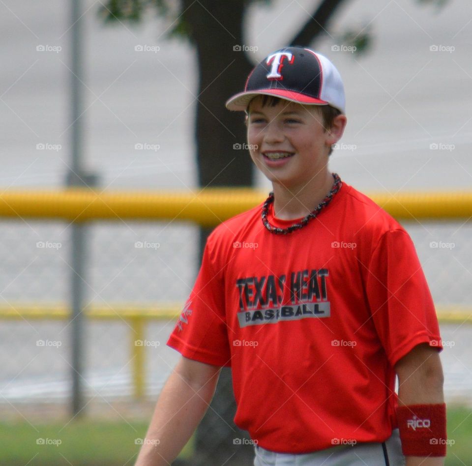 Happy, smiling youth baseball player. 
