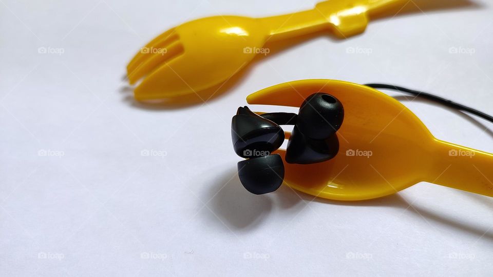 Yellow forks Trying to grab some music with earphones