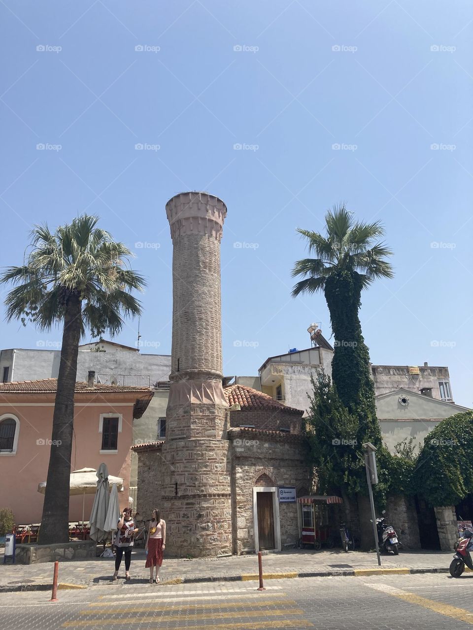 Greek village in Turkey. Blue sky and tall palm trees. Sunsets and sunny days. Summertime in Kusadasi. Vacation travel in Turkey . Summer view. Sunny day during vacation 
