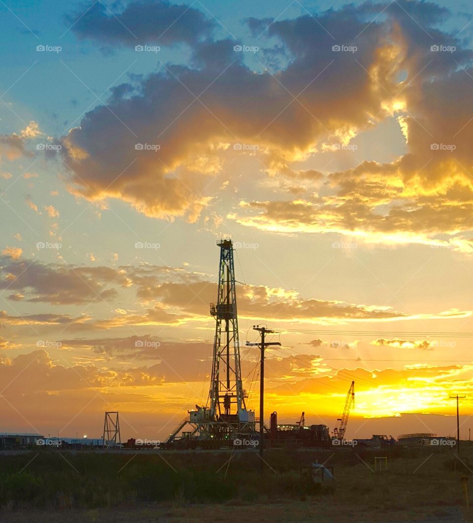 Oil rig at sunset. Golden hour at the oil rig.