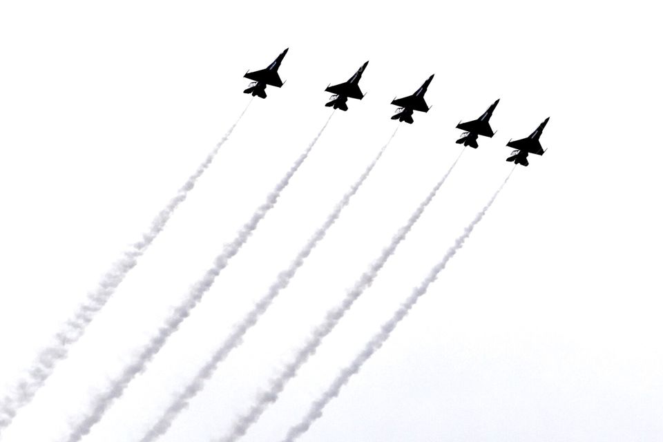 Black and white photo of fighter jets during aerial show performing stunts! 