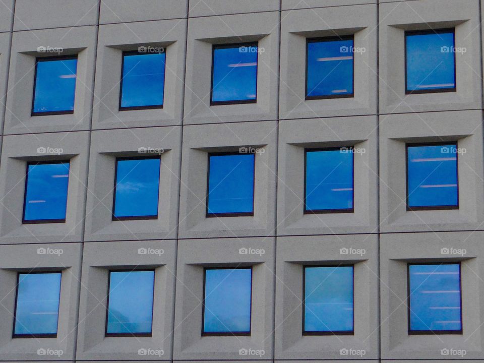 Blue windows . Office blovk windows reflectingbthe blue sky 