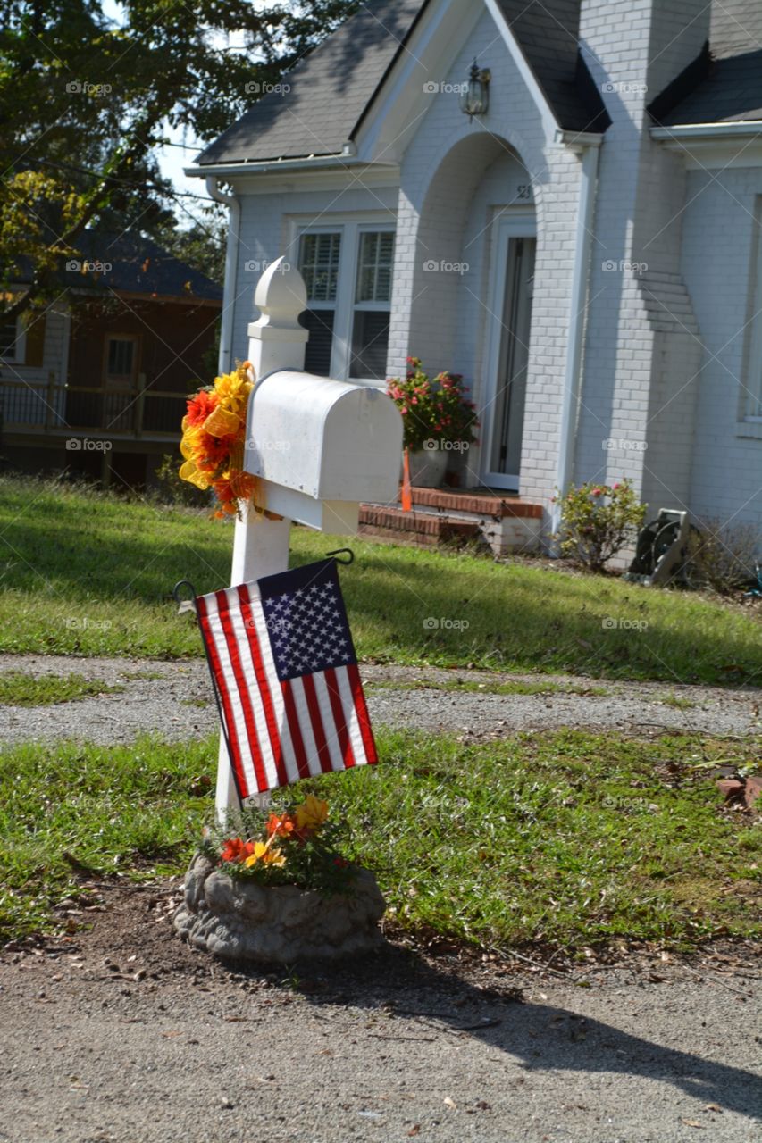 Fall Decorations and American Flag on a White Mail Box
