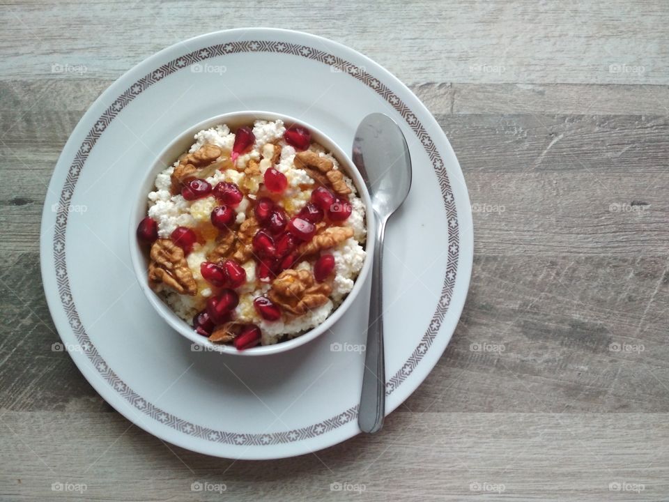 Healthy breakfast fresh cow cheese with nuts and honey.