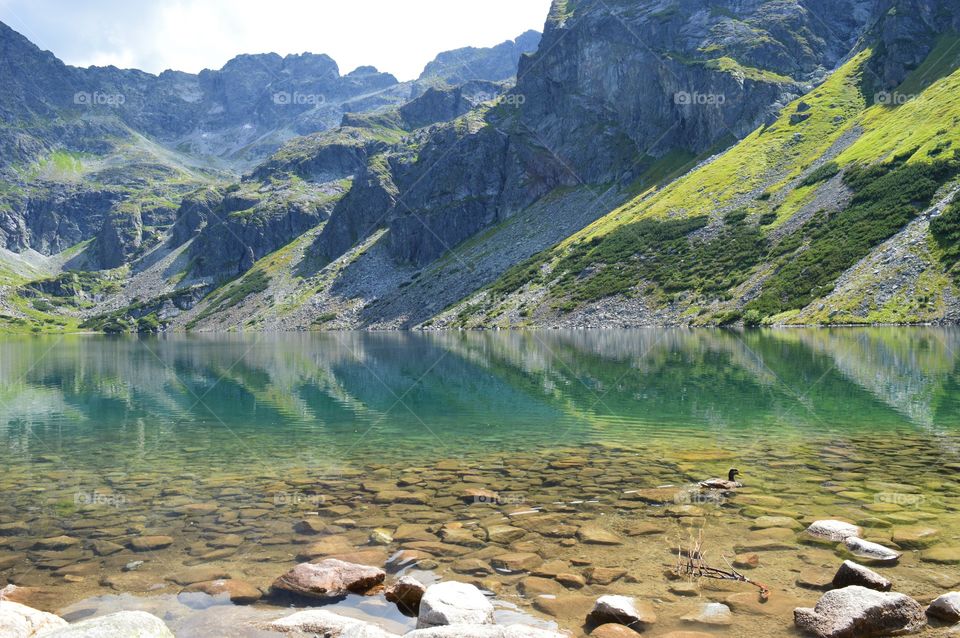 Rocky mountain reflecting on lake