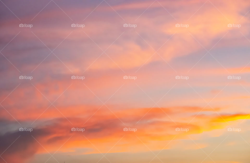 Sky and clouds reflected sunset light.