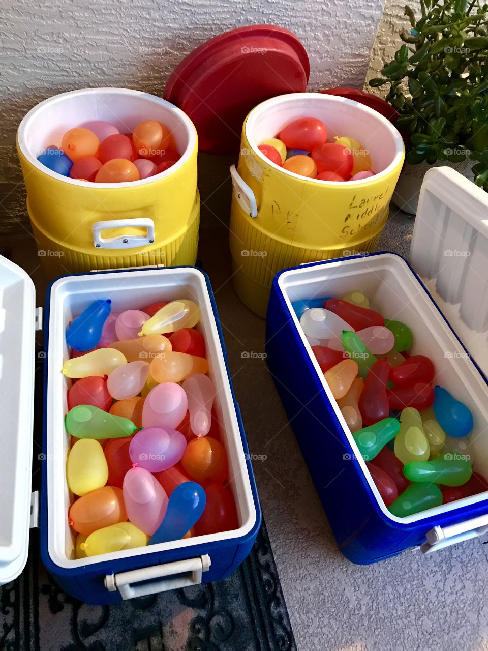 Four coolers filled with water balloons 