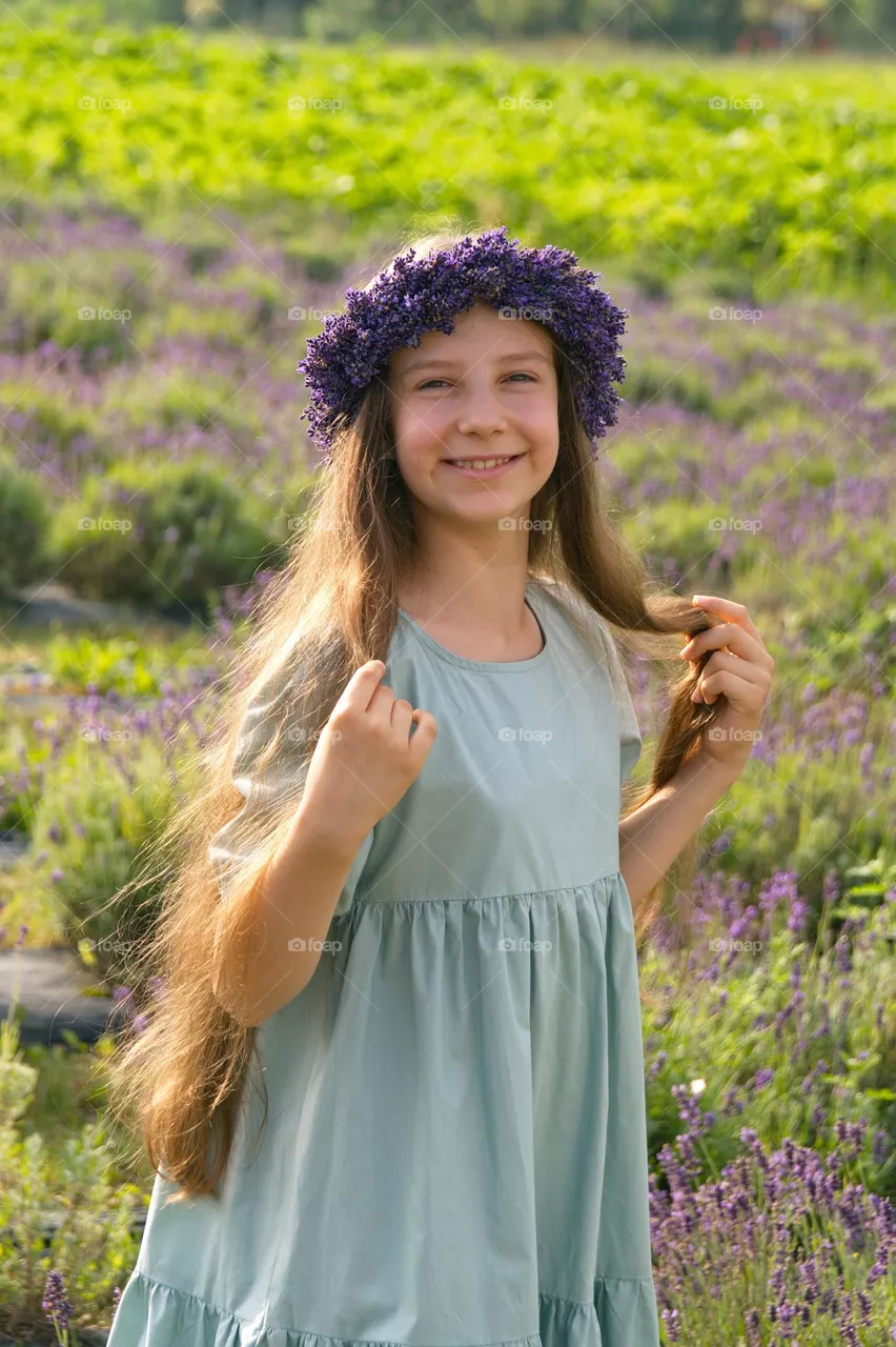 Young girl with long hair wearing a wreath of lavender