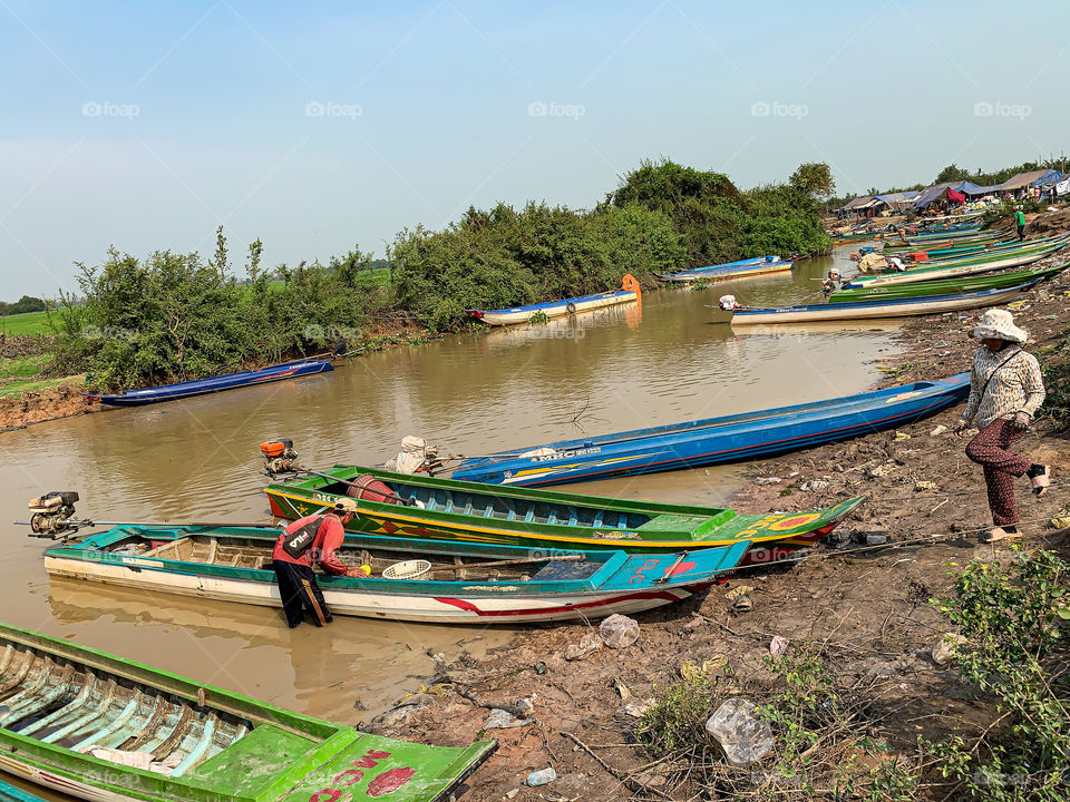 Many boats are in the river for park to taking the fish up in order to sell on market.