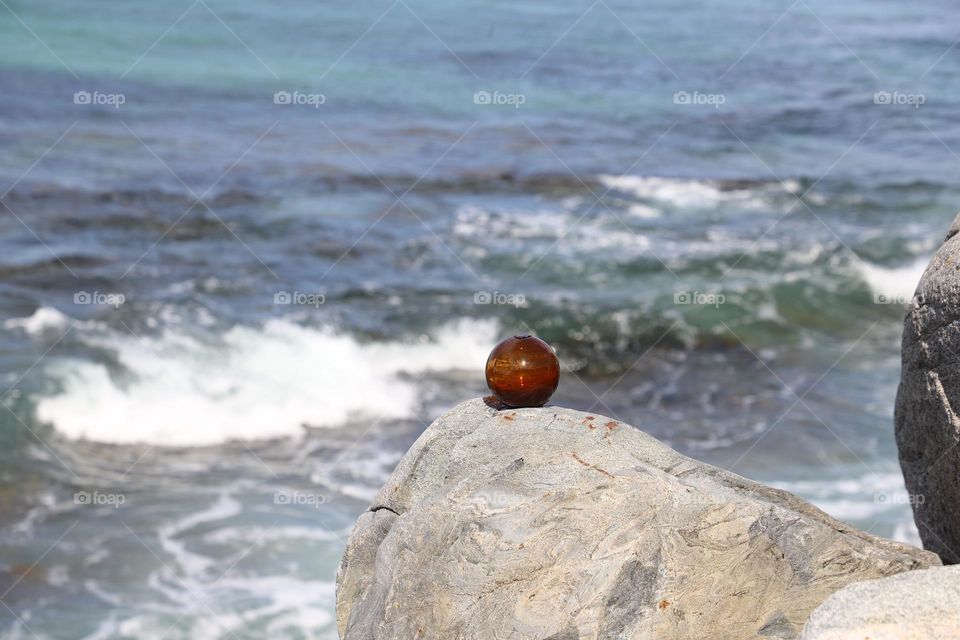 Glass ball on the rock