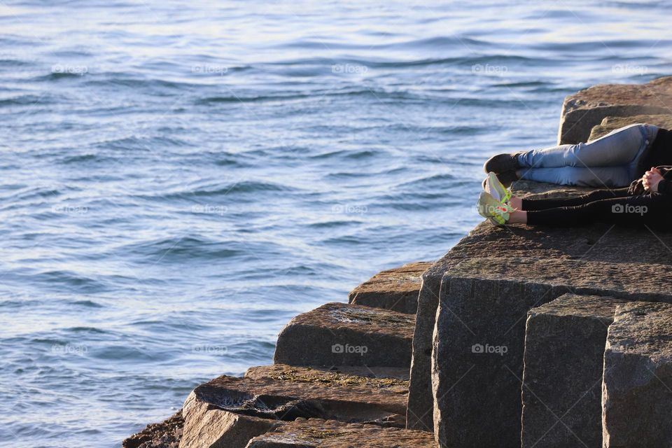 Relaxing on the stone steps by the ocean 