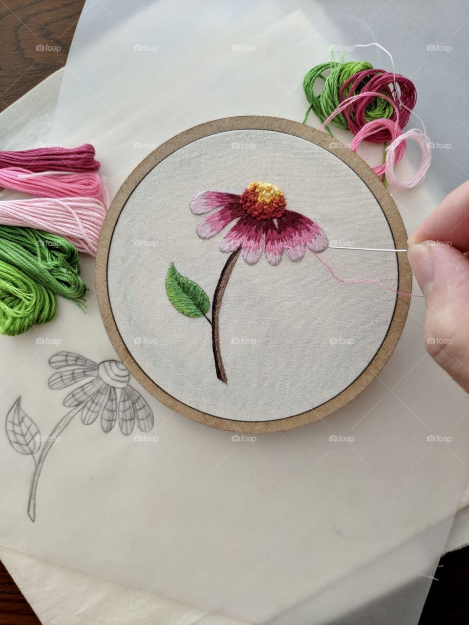 Making art! A pink flower made with hand embroidery and the lines and scratches used to make it 
