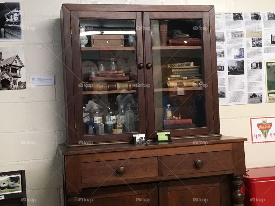 Medical books and medicine bottles in this case along with other things from the past.