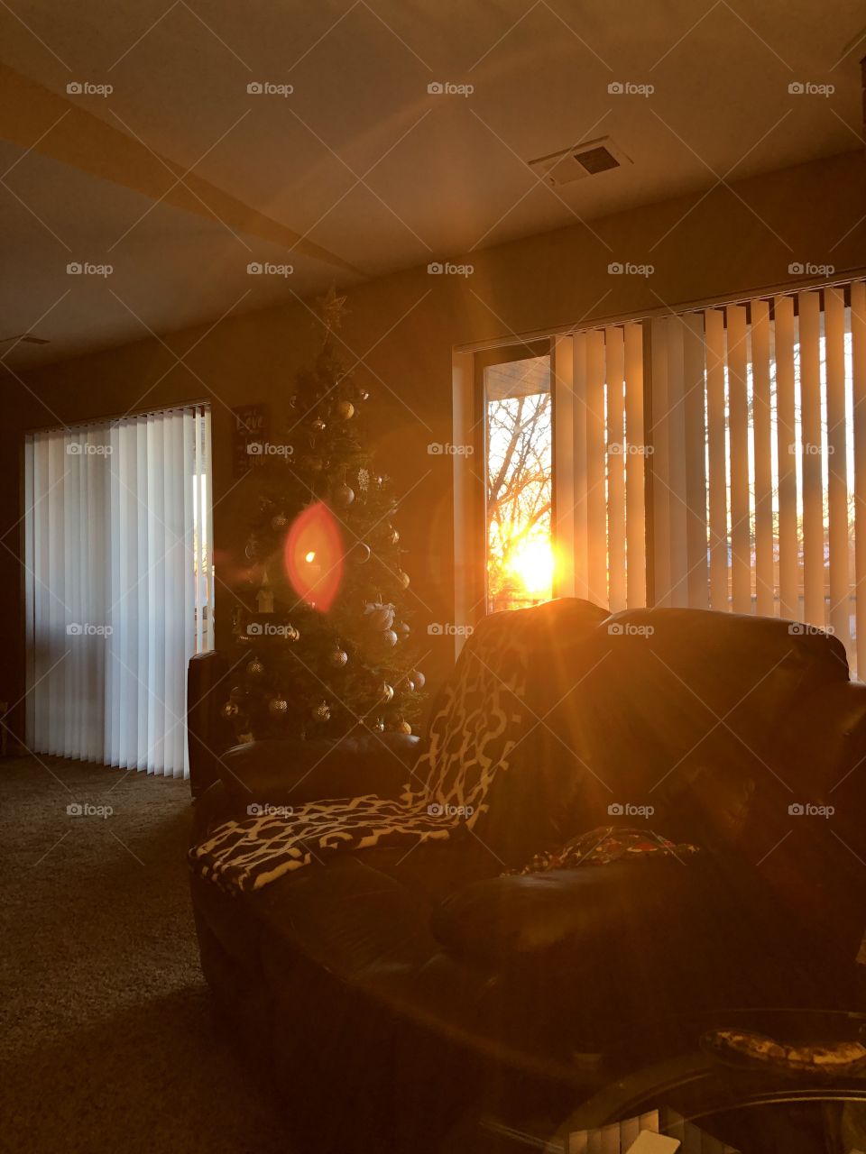 Lights and shadows. Sunset through the blinds. Cozy home. Christmas tree