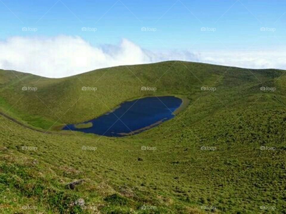 Optical illusion - an inclined lake Lagoa da Rosada on Pico Island occupying the crater of a dormant vulcano 900 m above the sea level.