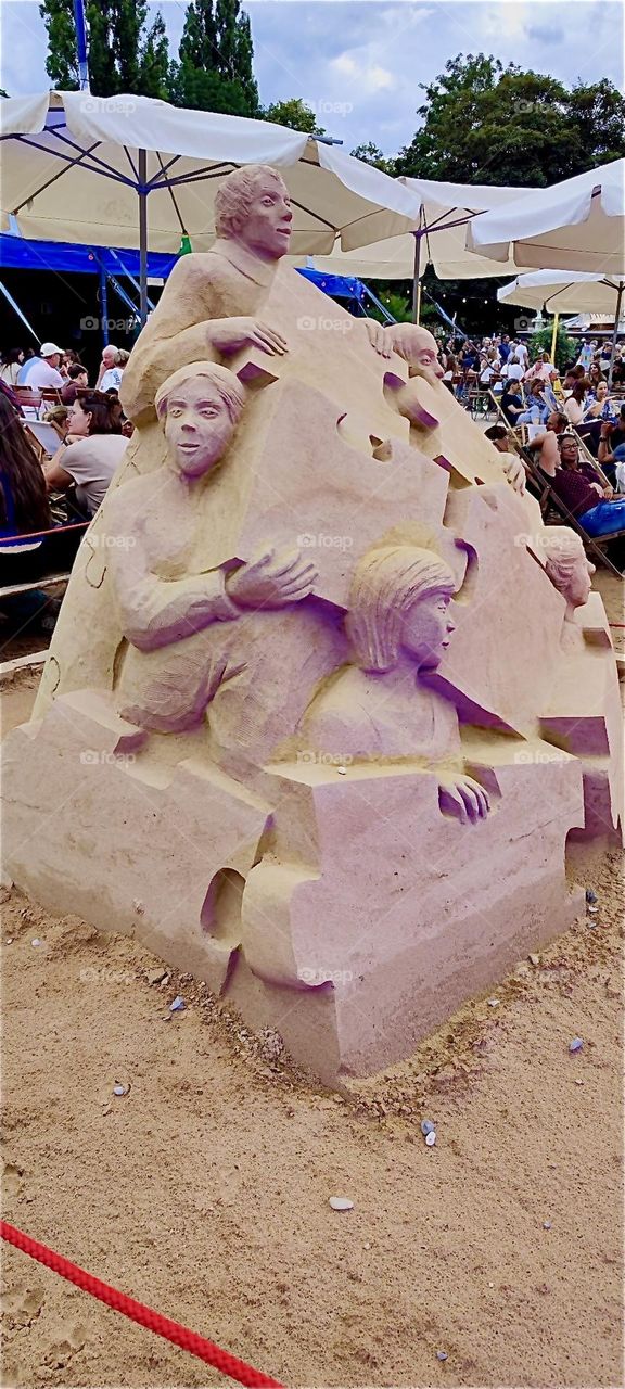 The “Tollwood House” summer festival also takes place at the “Olympiapark”, the stadium for the “1972 Olympics” in “Munich” that still attracts lots of tourists today. This large sand sculpture is on display for the event. 2024. Hypnotic Productions