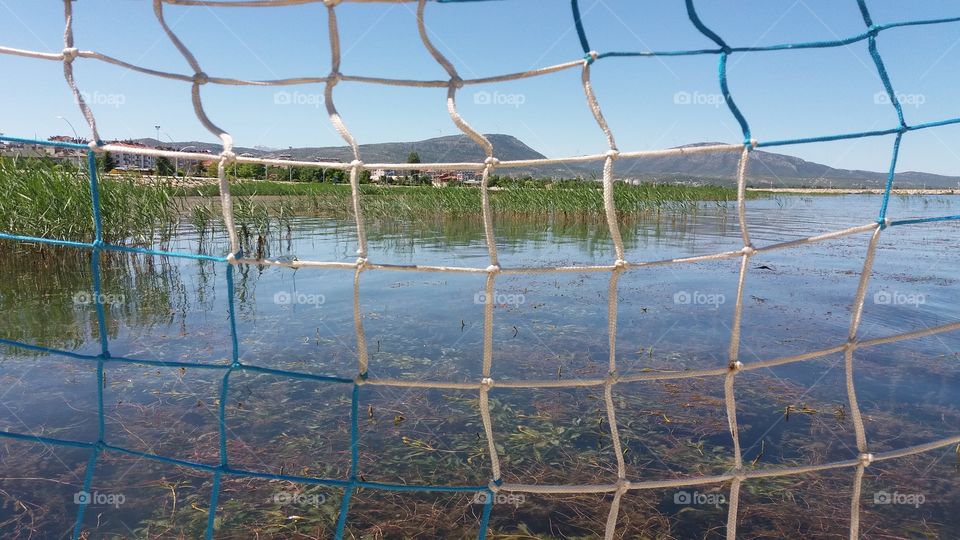 lake and mountains beyond nets