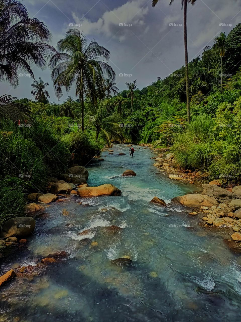 Panoramic landscape of bright blue river of dua rasa river and tropical rain forest