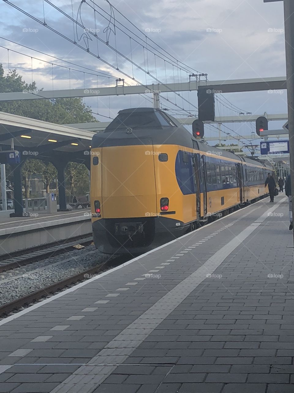 Train in Assen, Netherlands during the day. Train coming into the station. 