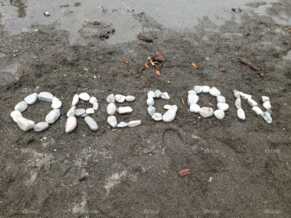 Beach word art with rocks.