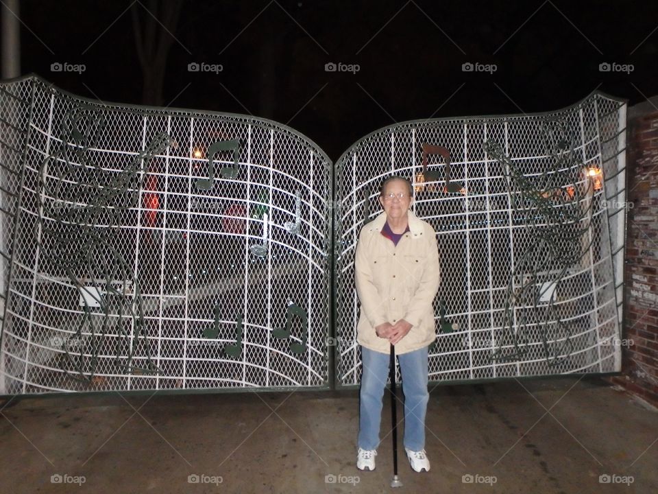 Senior man standing near gate