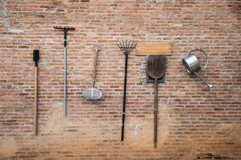 Farmer tool on the brick wall