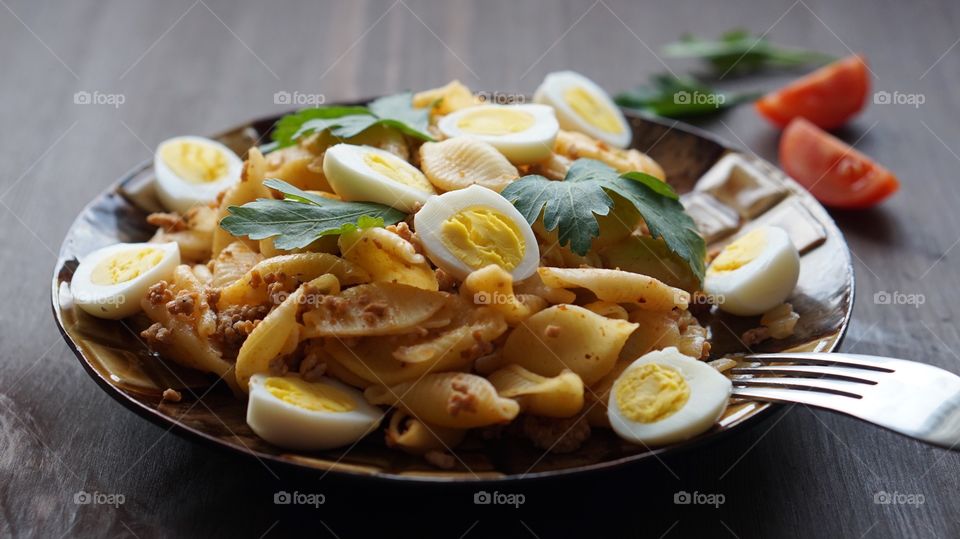 Boiled eggs and pasta in plate