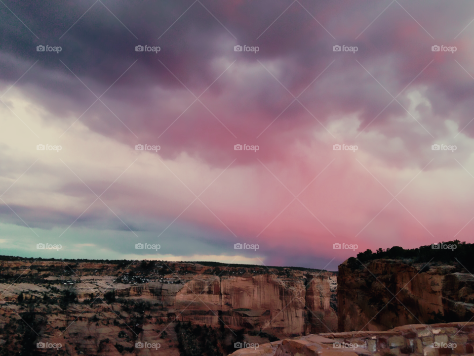 A stormy summer’s evening. Pink cotton candy clouds floating over the red rocks. 