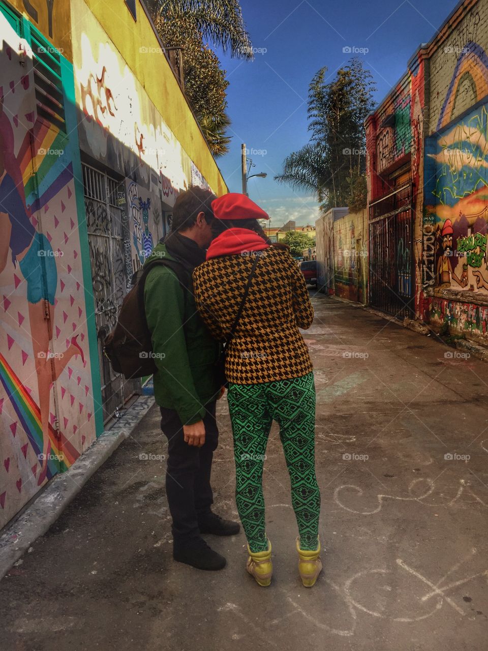 Two people standing near graffiti wall