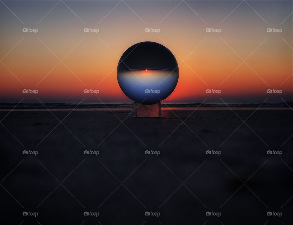 Sunrise over the Atlantic Ocean through a lens ball—taken in St. Augustine, Florida 