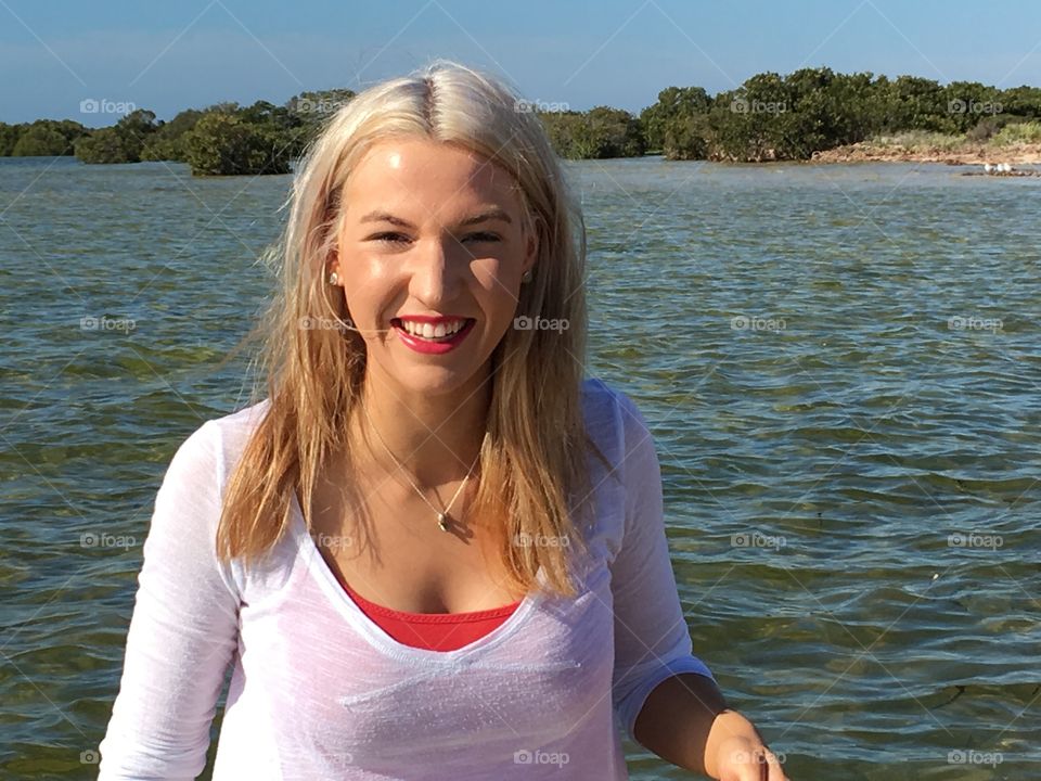 Smiling woman against lake