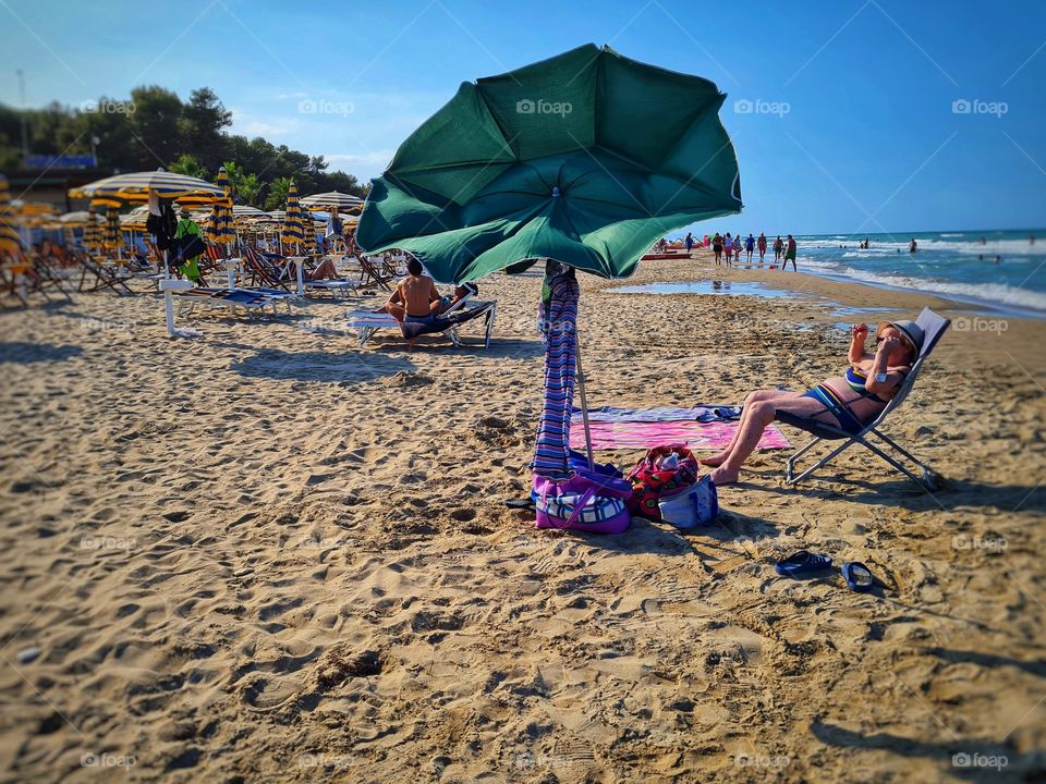 beach umbrella on the beach is about to fly away due to the wind!