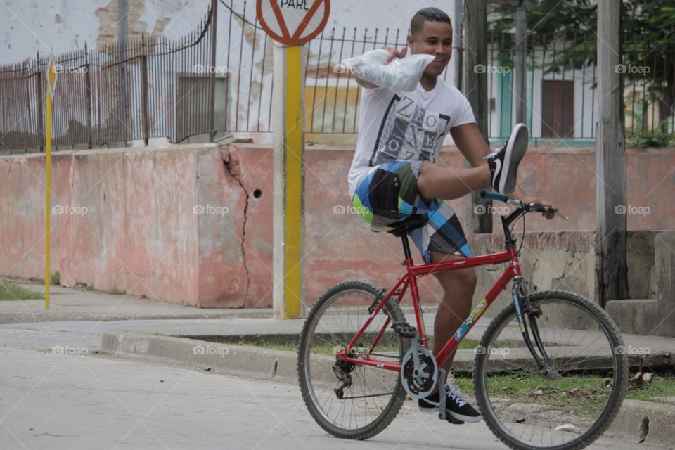 People In Cuba.Man Showing Off To People On Street