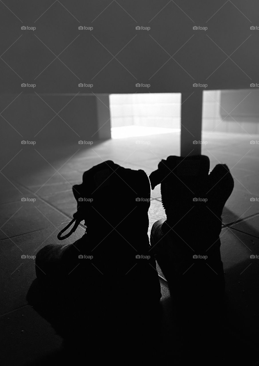 Military boots in locker room black and white 