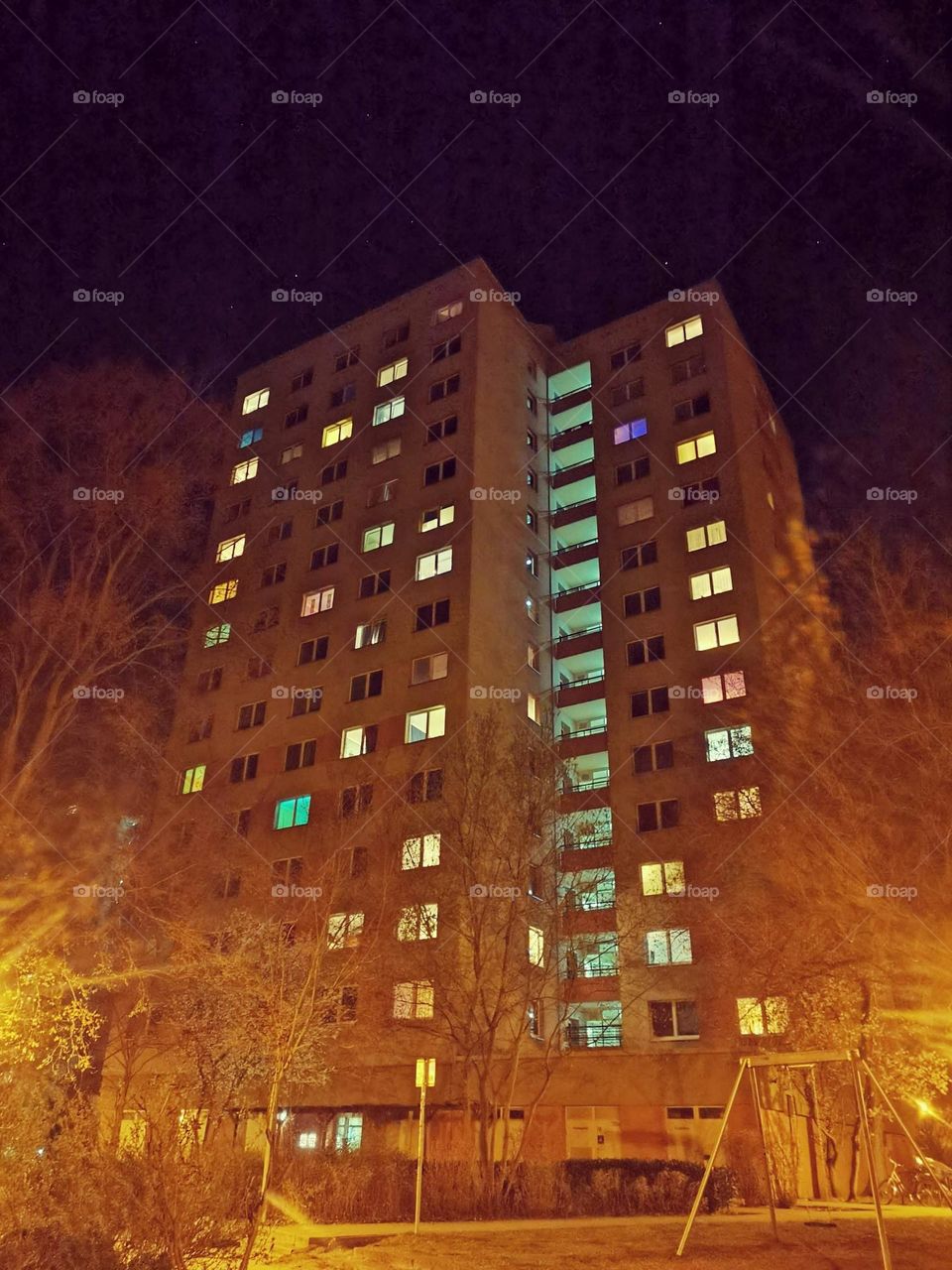High angle view of a tower block at the evening with lightened window