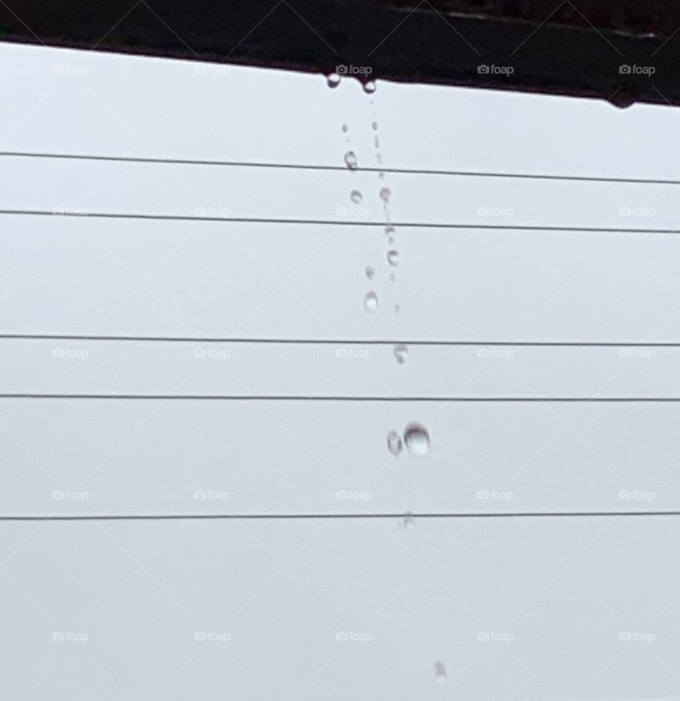 Torrential rain falling from steel roof 