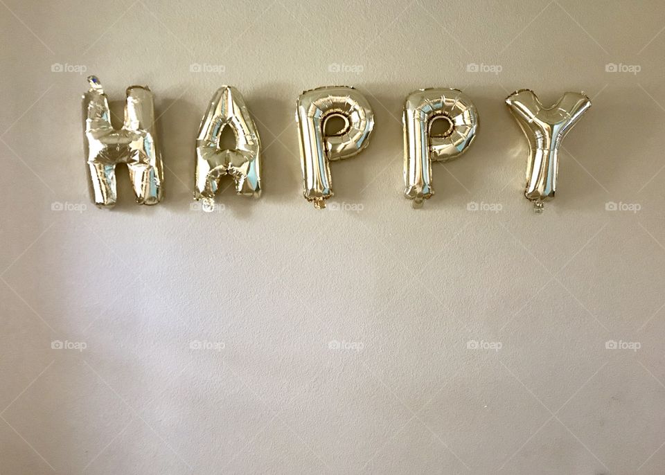 Golden bright bubble letter balloons that spell HAPPY. Happy Birthday balloons. USA, America 