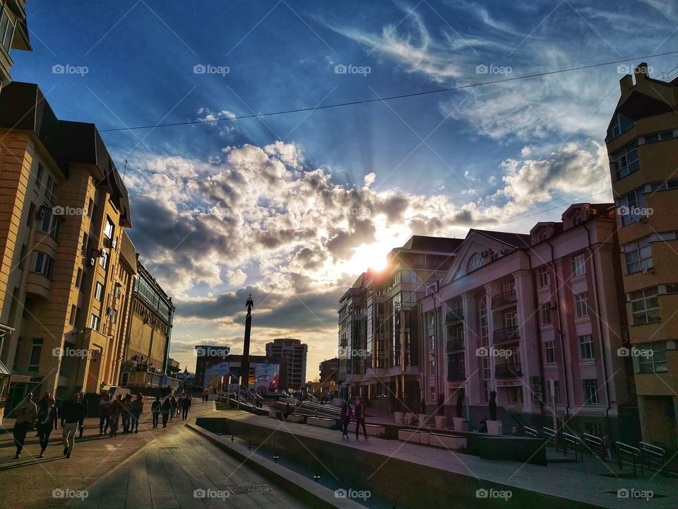 City town street day sun building way road sun sunny sunset clouds