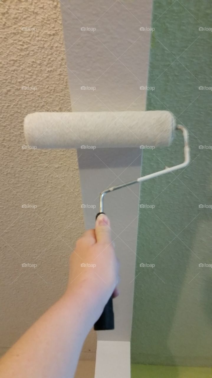 Painting part of a ceiling white with a roller