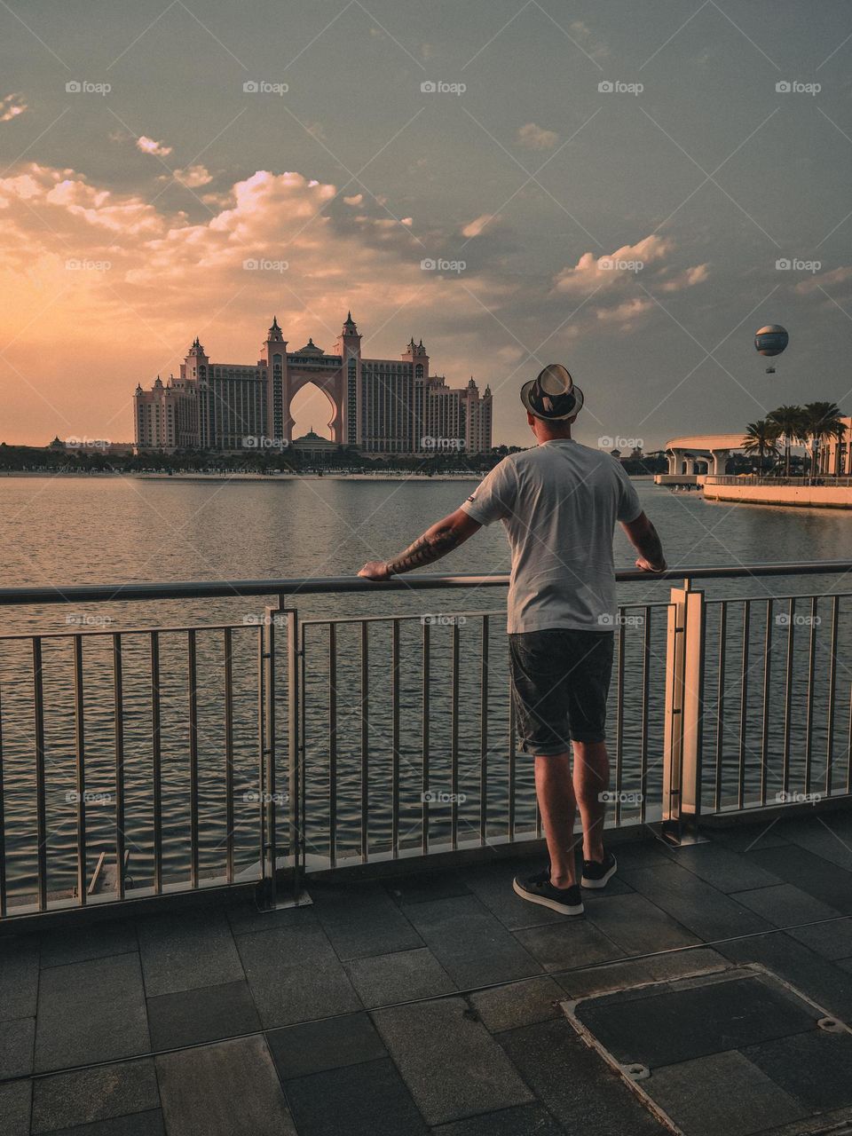 man standing with his back looking at sunset in a wonderful place Dubai