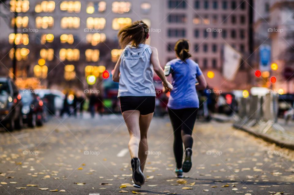 Close-up of girls running on street