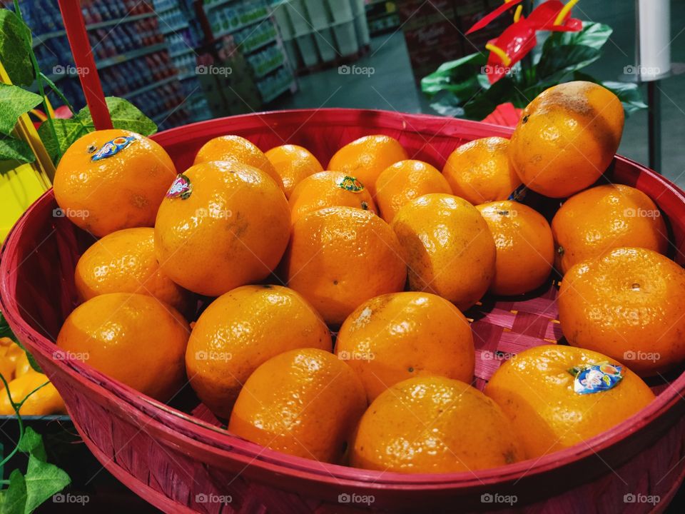 Very fresh oranges in Indonesian convenience stores with red baskets