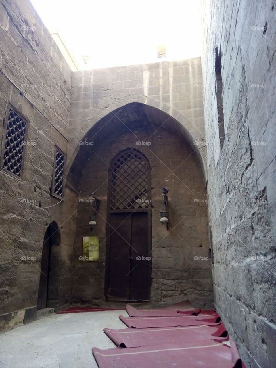An ancient space inside and old building. An arch doorway 