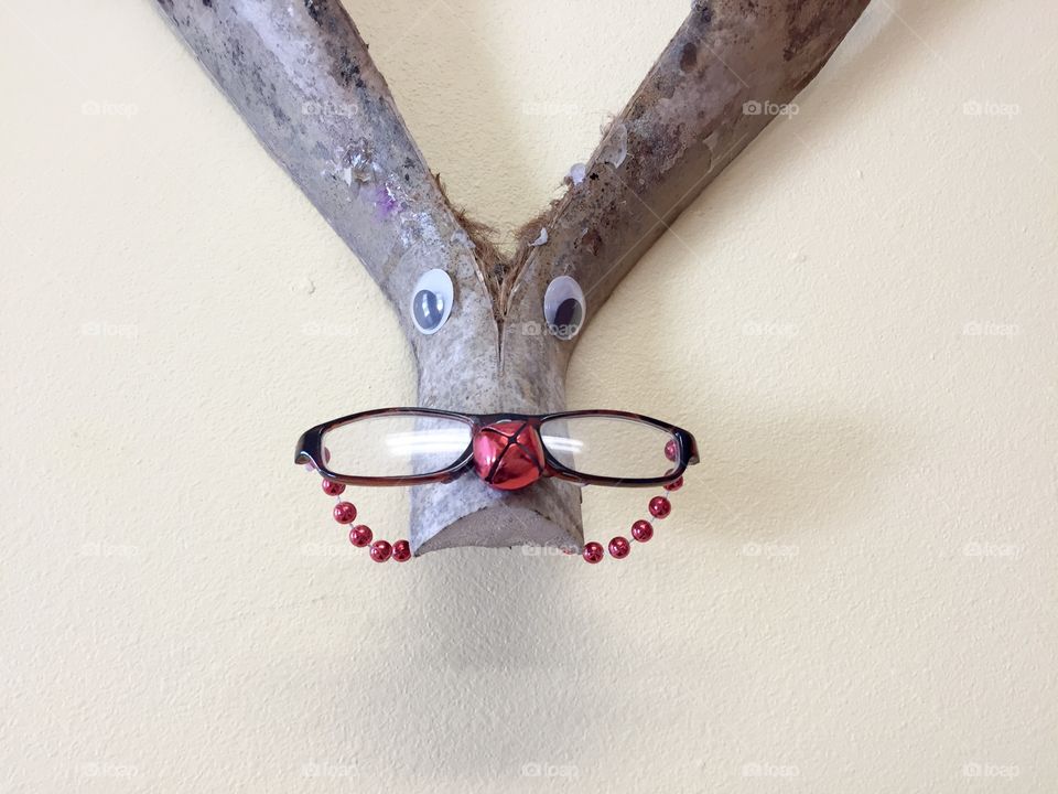 Wooden sculpture with glasses and red bells 