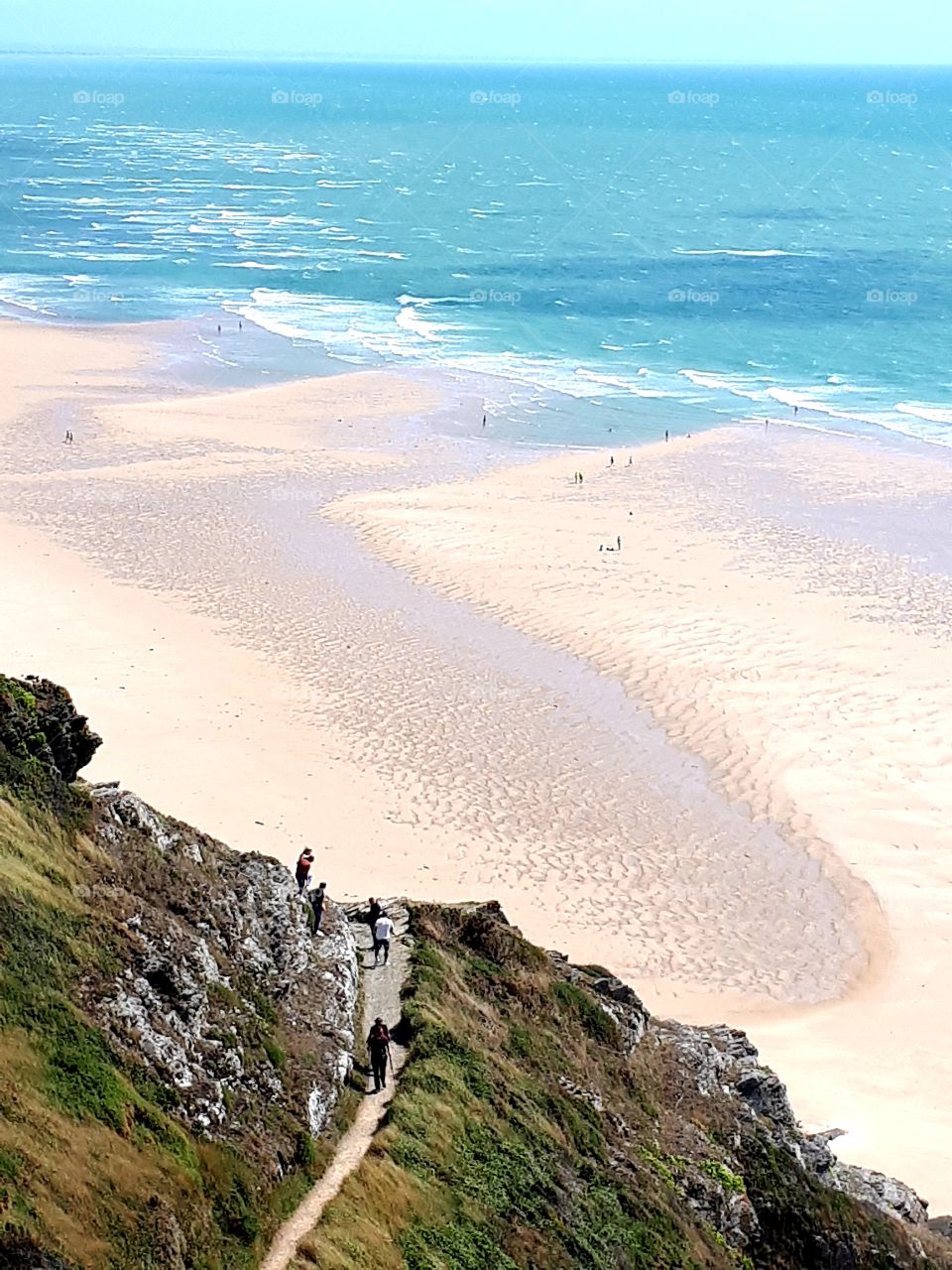 view of the beach  from the cliff above